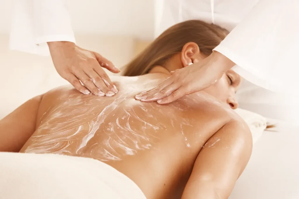 woman enjoying cream massage in spa