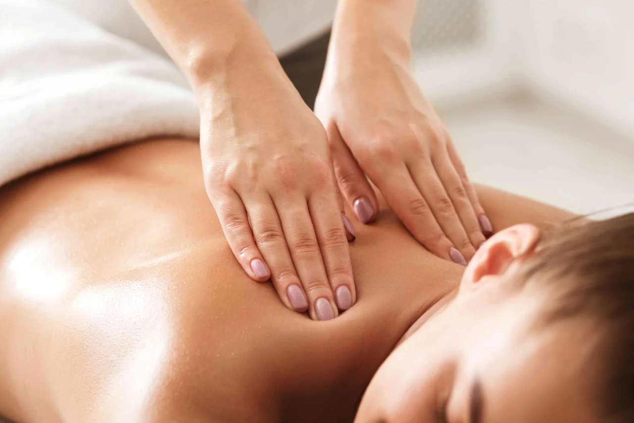 Therapist performing Swedish body massage using gentle and smooth strokes