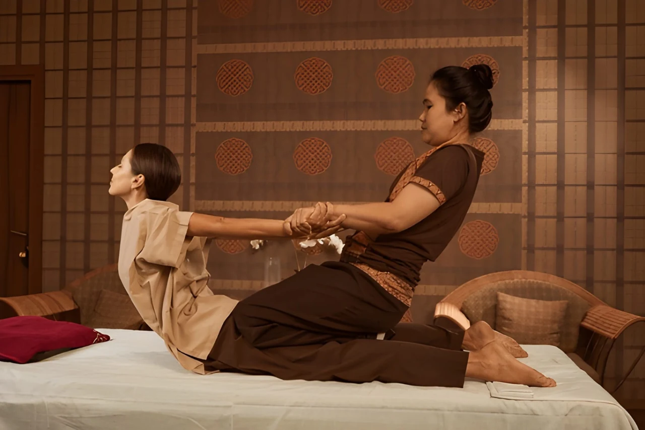 Experienced therapist performing traditional Thai body massage